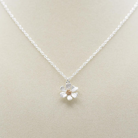 Elizabeth Jewelry Hammered Flower Necklace on jewelry form