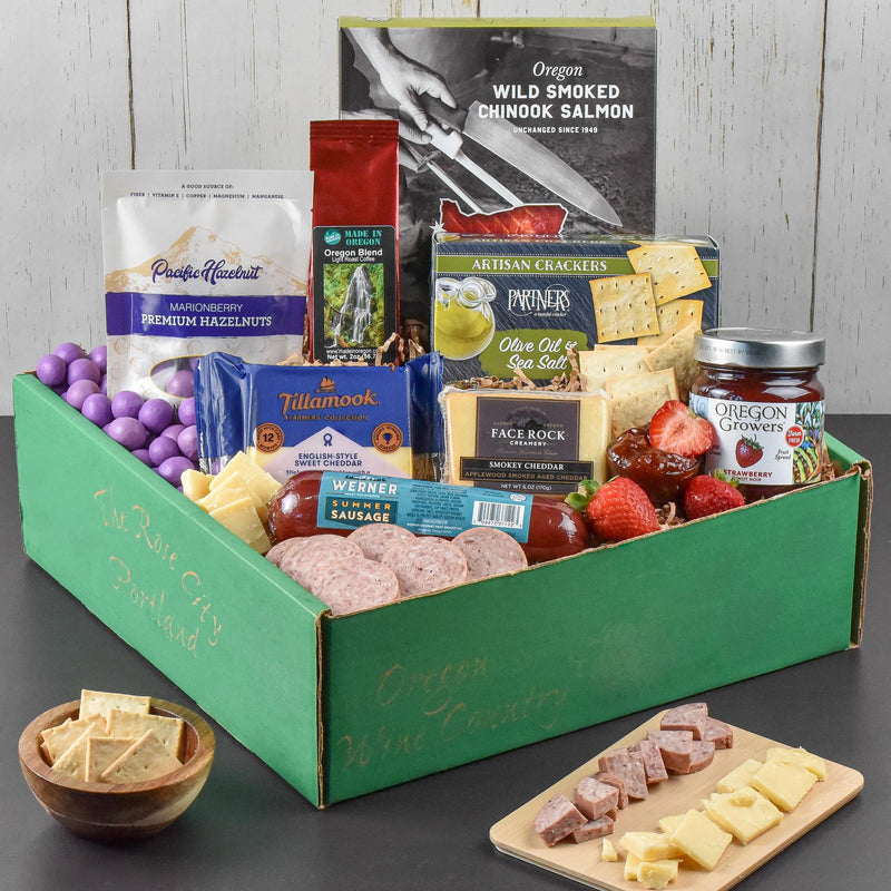 Load image into Gallery viewer, Oregon's Best Cheese Gift Basket with an assortment of foods in a green gift box