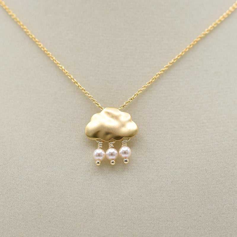 Load image into Gallery viewer, belva ann gold raincloud necklace on jewelry form
