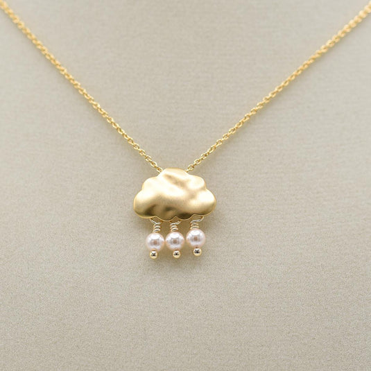 belva ann gold raincloud necklace on jewelry form