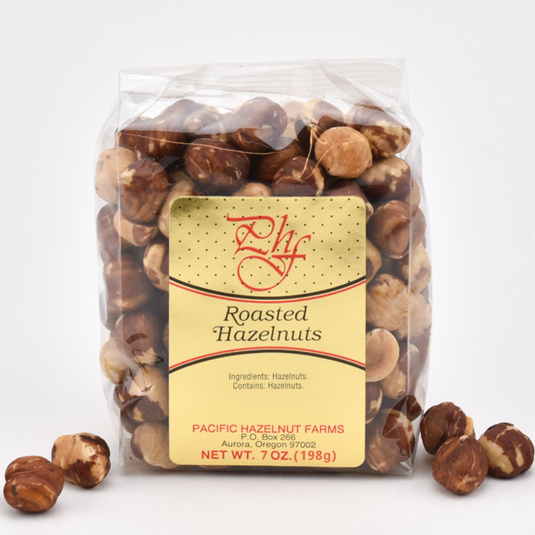 Pacific Hazelnut Farms 7 oz. clear bag of Dry Roasted Hazelnuts.