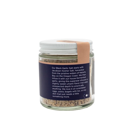Jacobsen Salt Co. Infused Black Garlic Salt 2.5 oz glass jar with back of label providing information about the salt