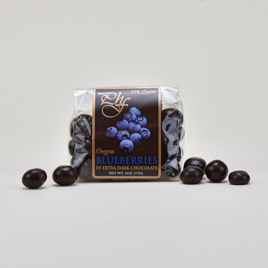 Pacific Hazelnut Farms 4 oz. clear bag of Oregon blueberries coated in  61% Guittard extra dark chocolate.