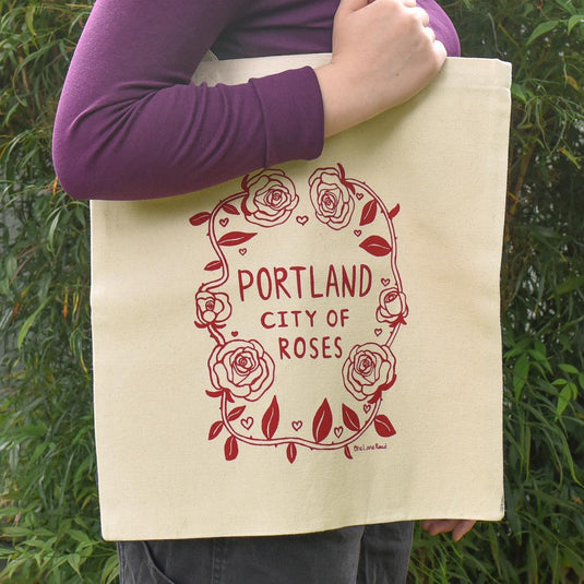 One Lane Road Portland City of Roses Canvas Tote Bag on model