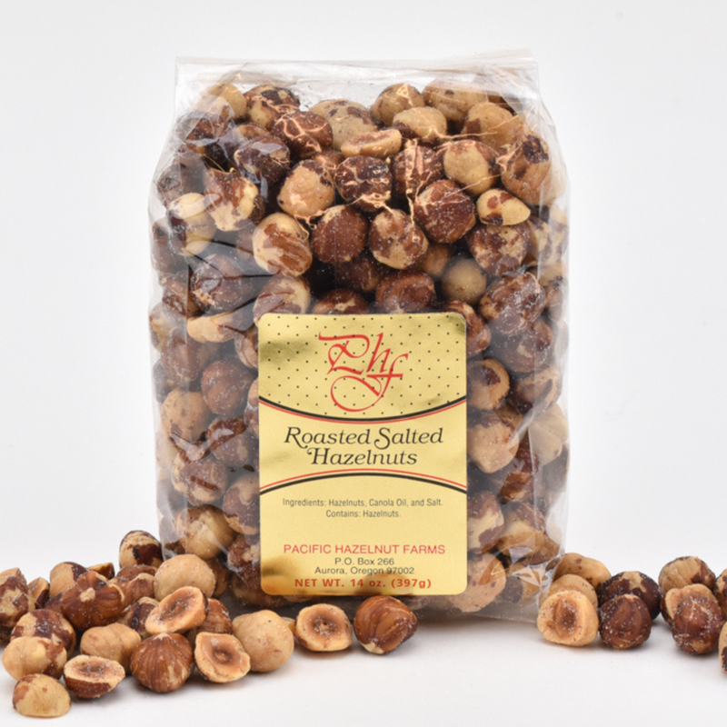 Load image into Gallery viewer, Pacific Hazelnut Farms Roasted Salted Hazelnuts in a 14oz clear bag.
