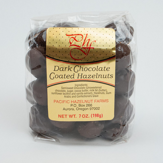 Pacific Hazelnut Farms 7 oz. Dark Chocolate Coated Hazelnuts in a clear bag.