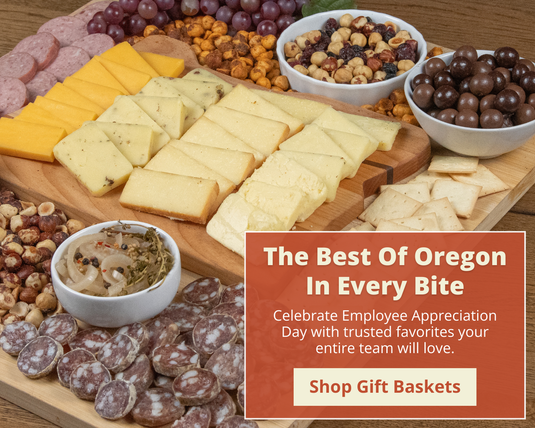 Image with assorted cheeses, meats, and snacks on a wooden board. The Best of Oregon In Every Bite, Shop Gift Baskets.