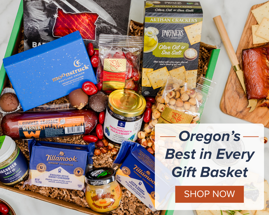 Oregon's Best In Every Gift Basket with image of gift box filled with cheese, sausage, nuts, chocolate truffles, jam, and more.